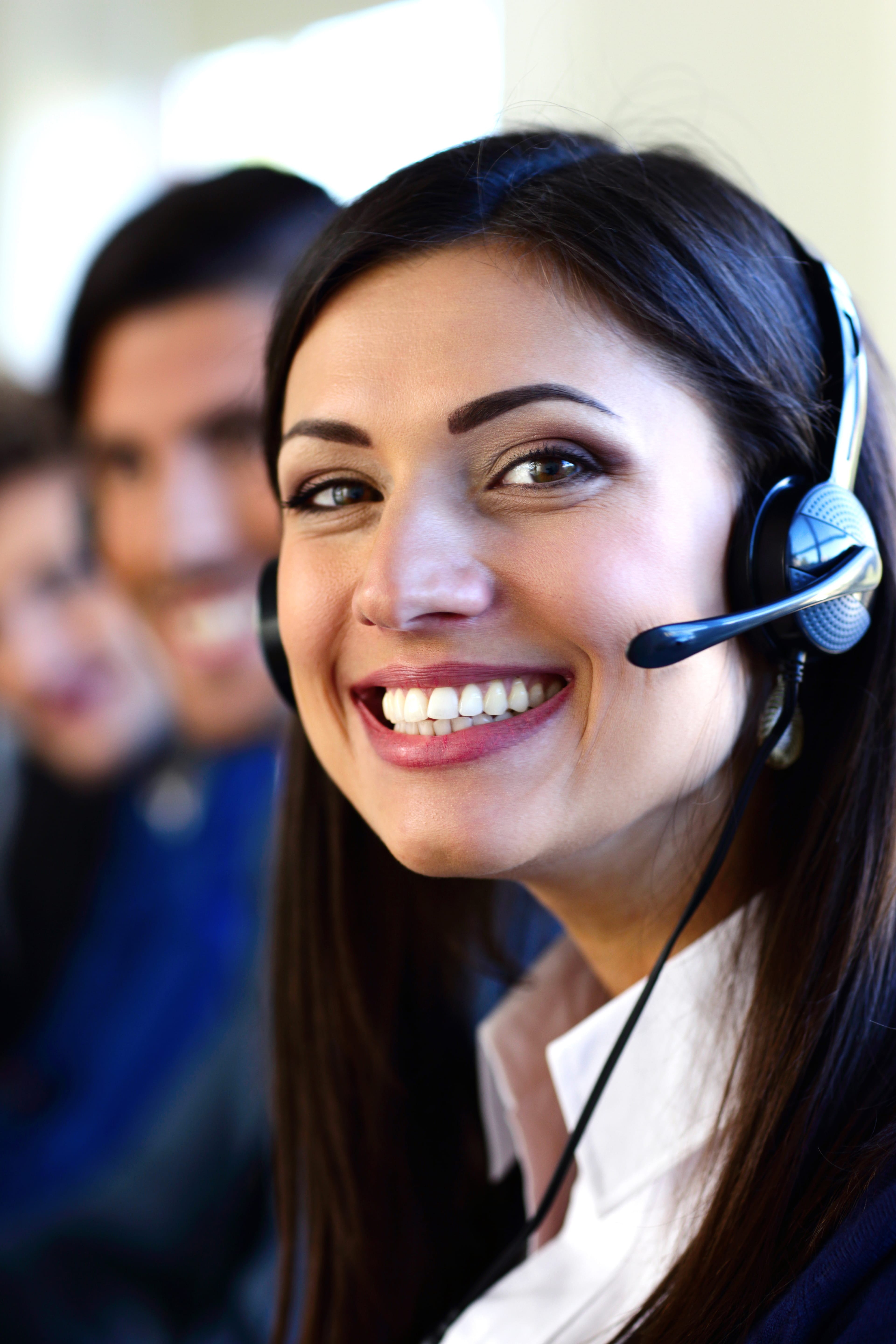 Happy young businesspeople and colleagues in a call center office